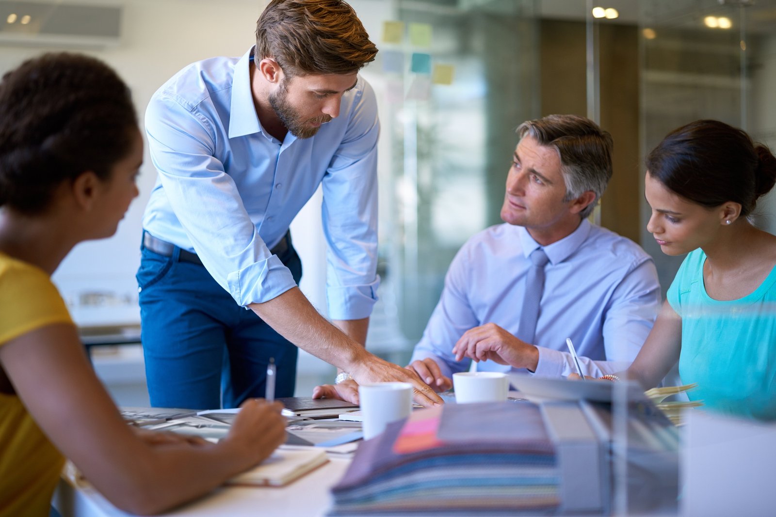 Im looking at this in particular. Cropped shot of four businesspeople in a meeting.