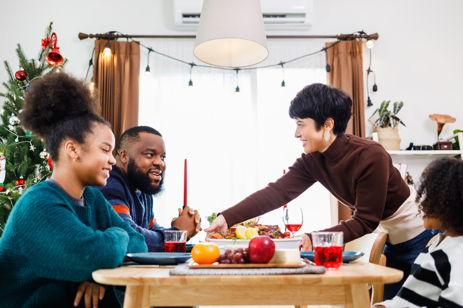 African American family. Merry Christmas. Happy family are having dinner at home.